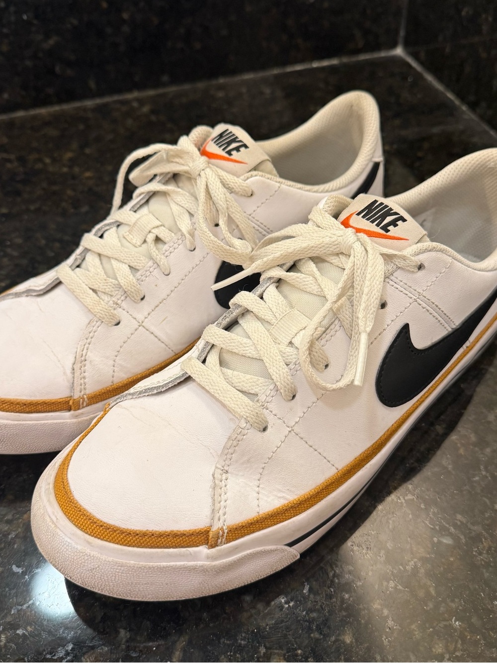 Nike Women’s White Sneakers with Black Swoosh and Gold Trim